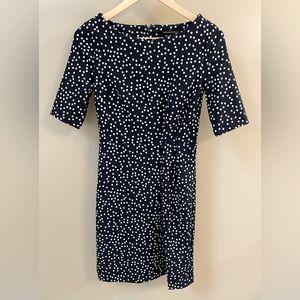 Knee-length profession navy & white dot dress. Gather on left, semi-fitted style